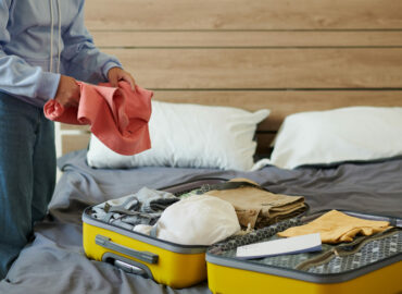 Cropped image of college girl packing suitcase to leave for university